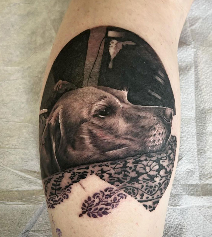 Realistic dog tattoo with intricate details on the leg, showcasing unique animal tattoo artistry.
