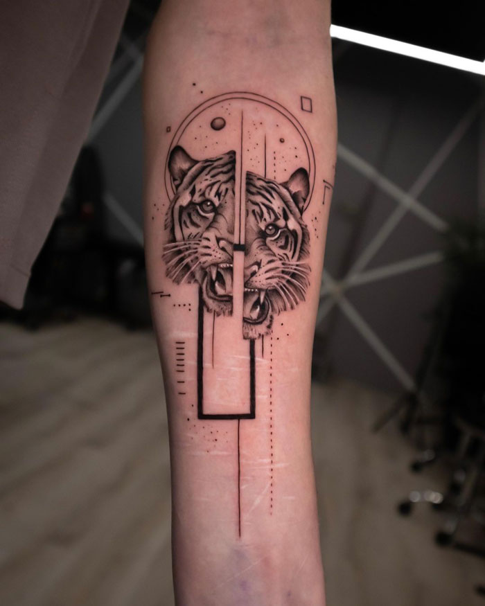 Abstract tiger tattoo on forearm, celebrating the animal kingdom with geometric elements.