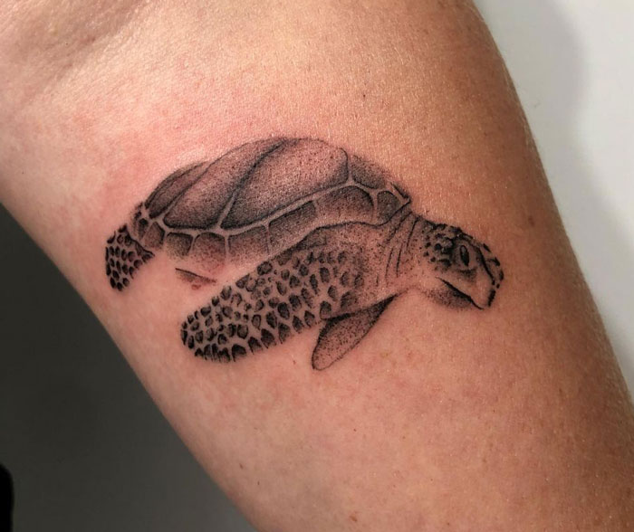 Tattoo of a detailed sea turtle on skin, showcasing creative animal tattoo design ideas.