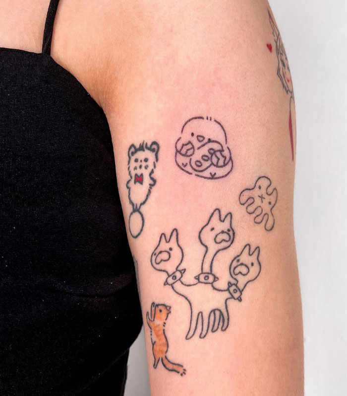 Arm with quirky animal tattoos, featuring a three-headed creature, adding creative flair to tattoo ideas.