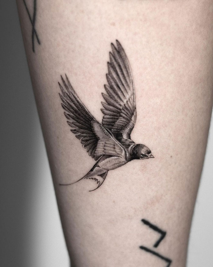 Tattoo of a swallow flying, detailed design celebrating the animal kingdom.