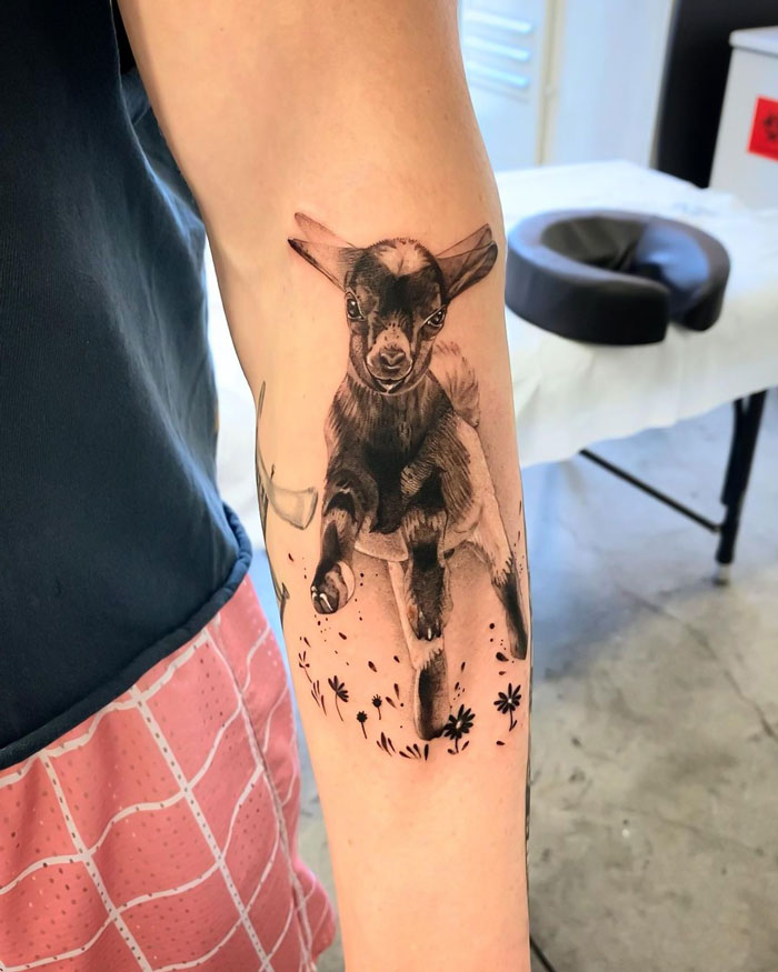 Realistic animal tattoo of a goat on a person's forearm, showcasing simplicity and detail.