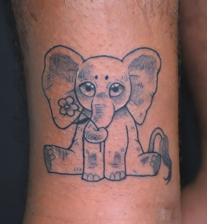 Cute elephant tattoo design with a flower, perfect for animal tattoo inspiration.