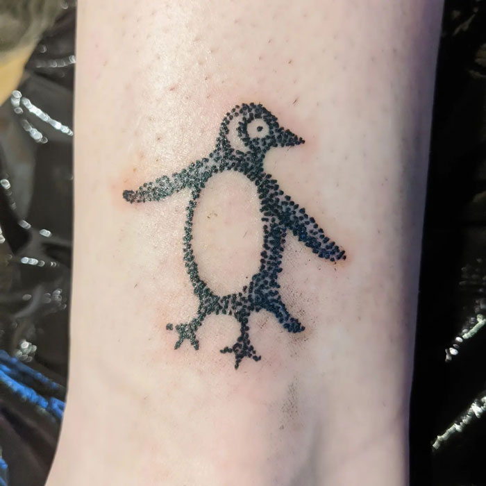 Penguin tattoo celebrating the animal kingdom, created with dotwork technique on skin.