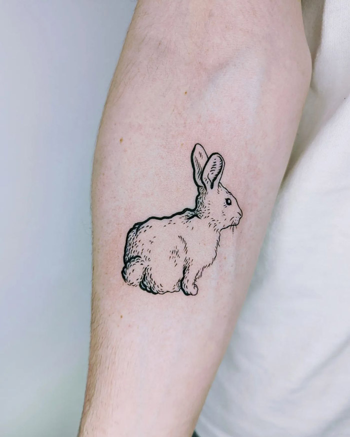 Realistic rabbit tattoo design on a forearm, showcasing simplicity in animal tattoo art.
