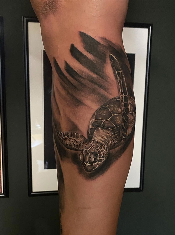 Sea turtle tattoo on arm, showcasing intricate detail and shading, celebrating the animal kingdom.