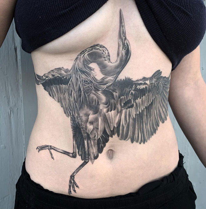 Tattoo of a detailed bird design on someone's torso, showcasing a creative animal tattoo idea.