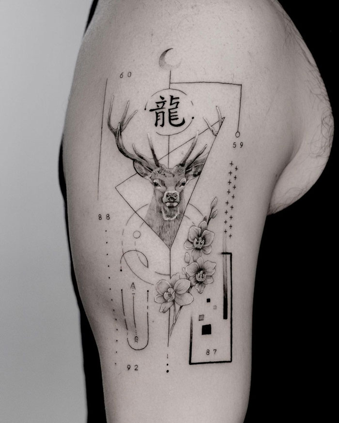 Deer tattoo design with geometric shapes and flowers on upper arm.