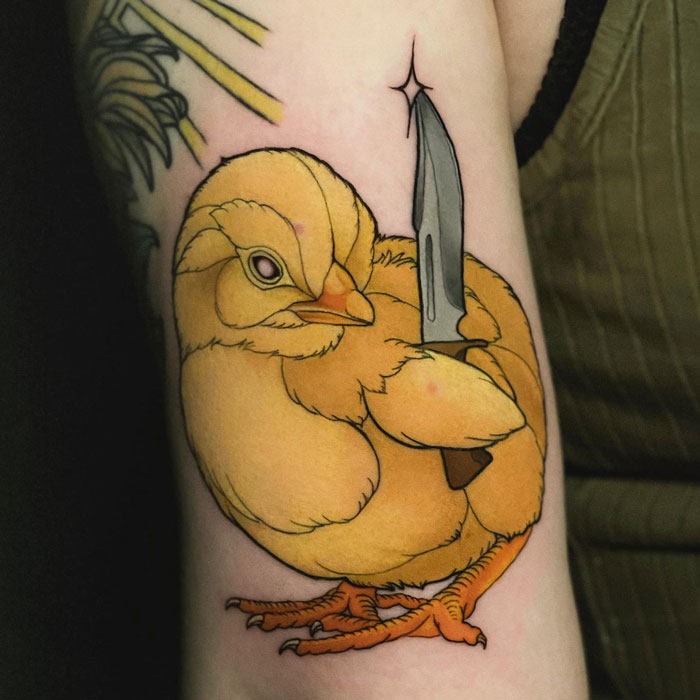 Chick tattoo holding a knife, illustrating creative animal tattoo ideas.