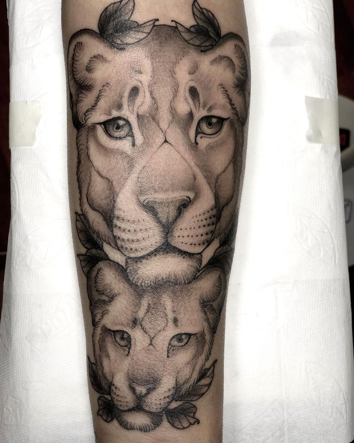 Realistic lion tattoo capturing simplicity and detailed artistry on forearm.