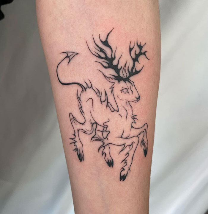 Minimalist deer tattoo with antlers on arm, showcasing simple animal realism.