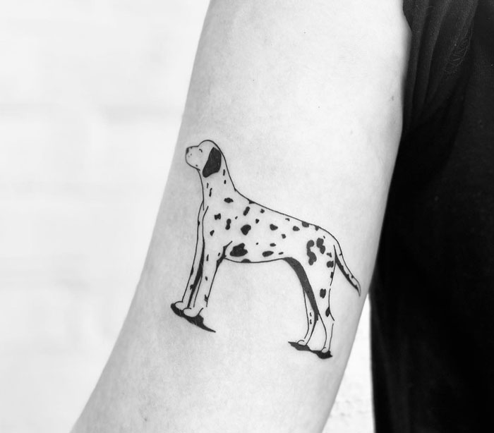 Dalmatian tattoo design on forearm, showcasing minimalist animal art.