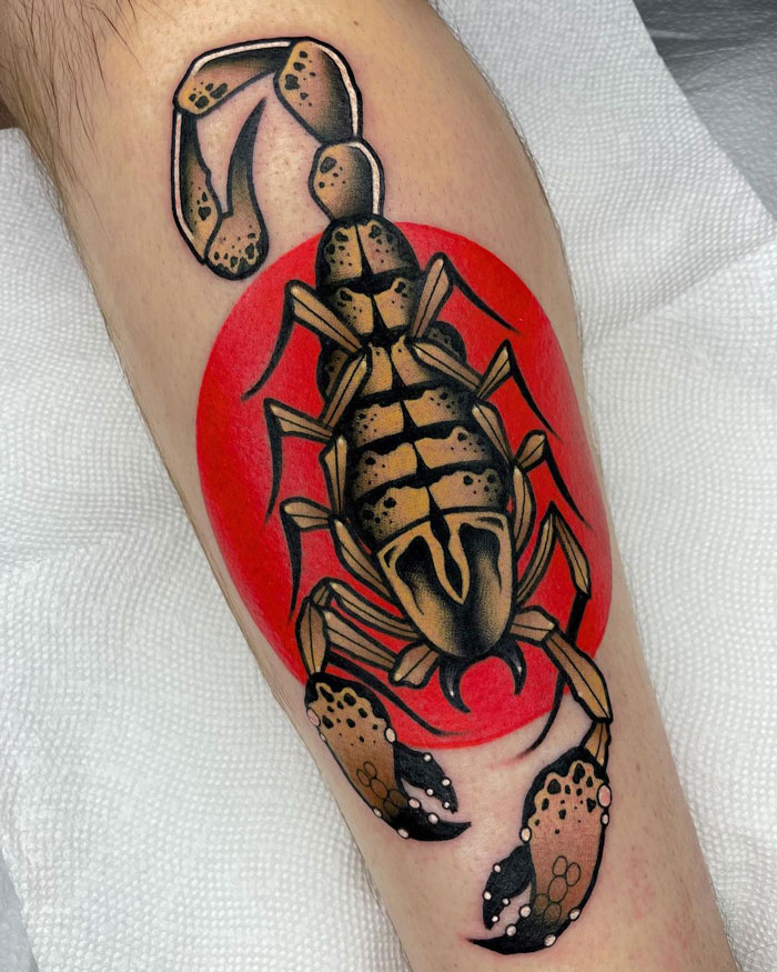 Scorpion animal tattoo with realistic details and simple design on skin, featuring a bold red background.