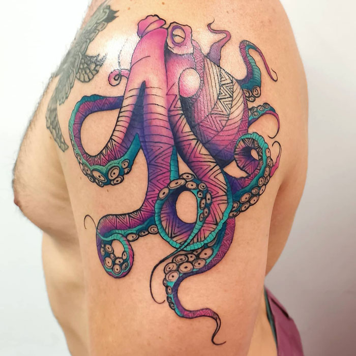 Colorful octopus tattoo on shoulder, showcasing intricate animal tattoo design with vibrant hues and detailed patterns.