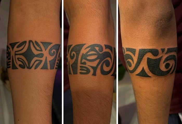 Tribal armband tattoo design on forearm showcasing intricate patterns.
