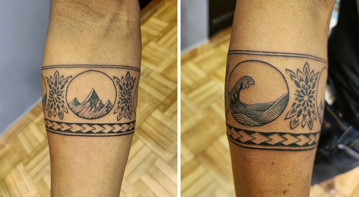 Armband tattoo featuring mountains and waves, showcasing intricate design and symbolism.