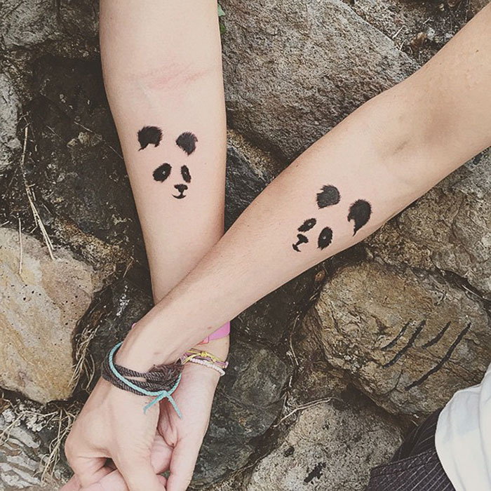 Two arms with matching panda face tattoos, symbolizing friendship with BFF tattoo designs.