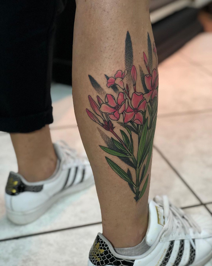 Colorful floral calf tattoo design showcasing pink flowers.
