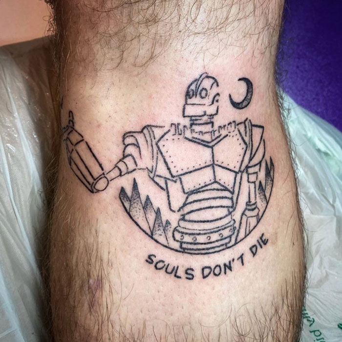 Lower leg tattoo featuring a robot with the text "Souls Don't Die."