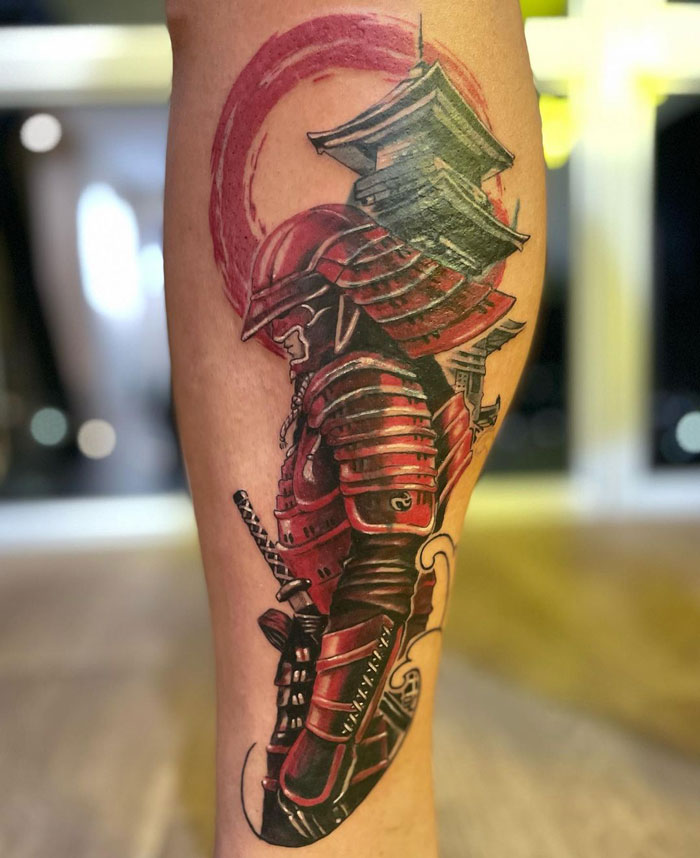 Samurai lower leg tattoo with red and black design featuring detailed armor and helmet.