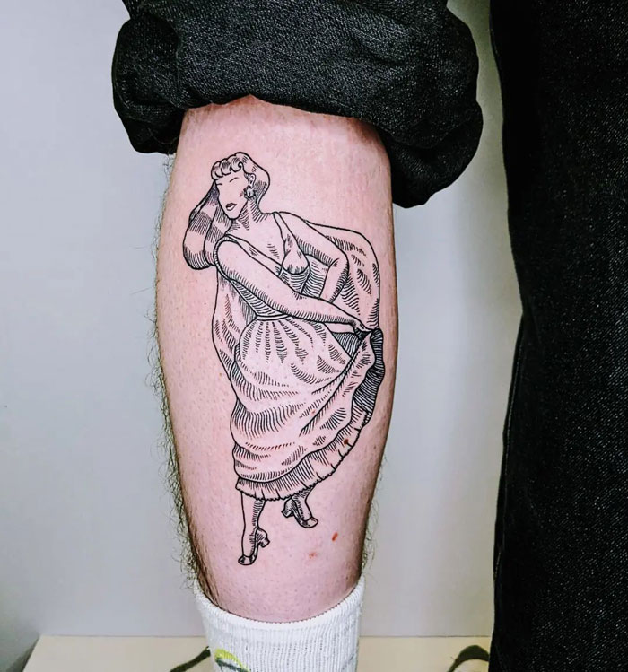 Unique calf tattoo featuring a line art pin-up girl design on the lower leg.