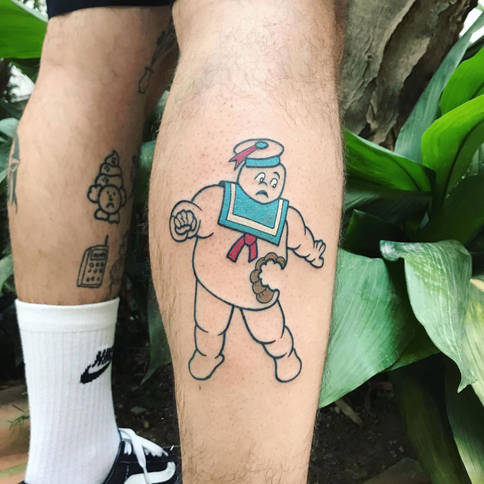 Lower leg tattoo featuring a cartoon sailor character with colorful details.