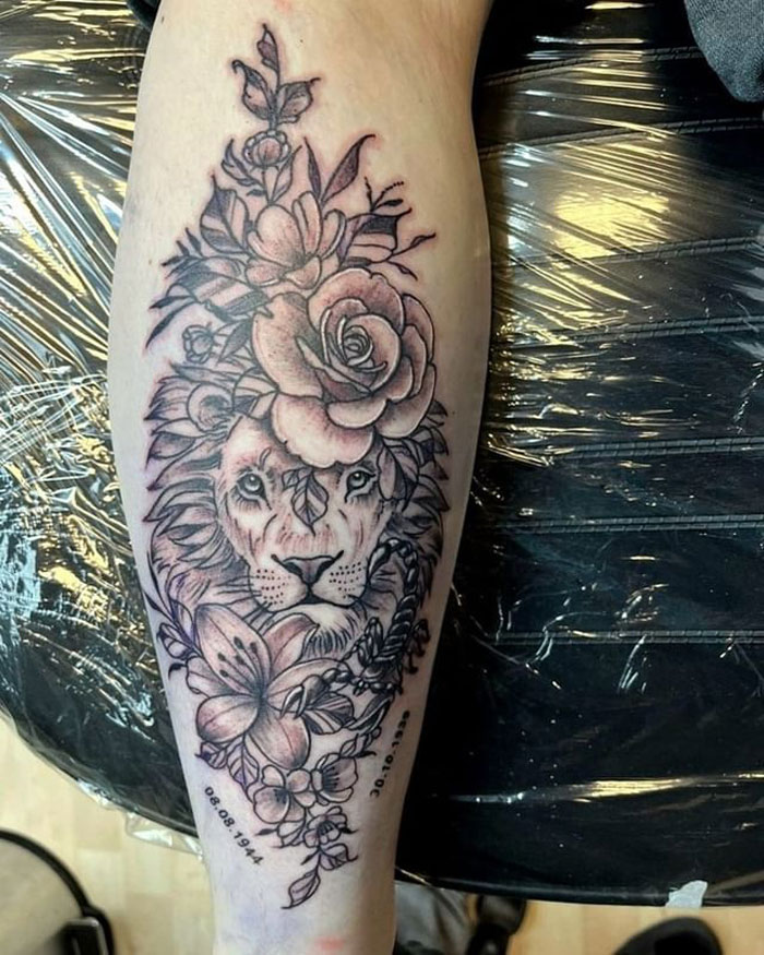 Lion and floral calf tattoo design, showcasing unique art and intricate detail.