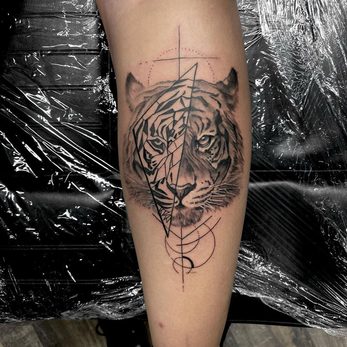 Calf tattoo featuring a geometric tiger design, showcasing cool and artistic elements.