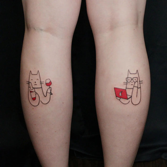 Cute cat tattoos on calves, one holding wine, the other with glasses and a laptop, showcasing cool calf tattoo ideas.
