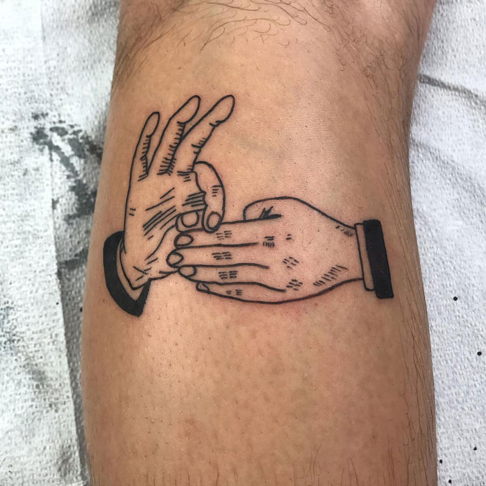 Unique calf tattoo featuring two hands in a playful gesture, demonstrating coolness and style.