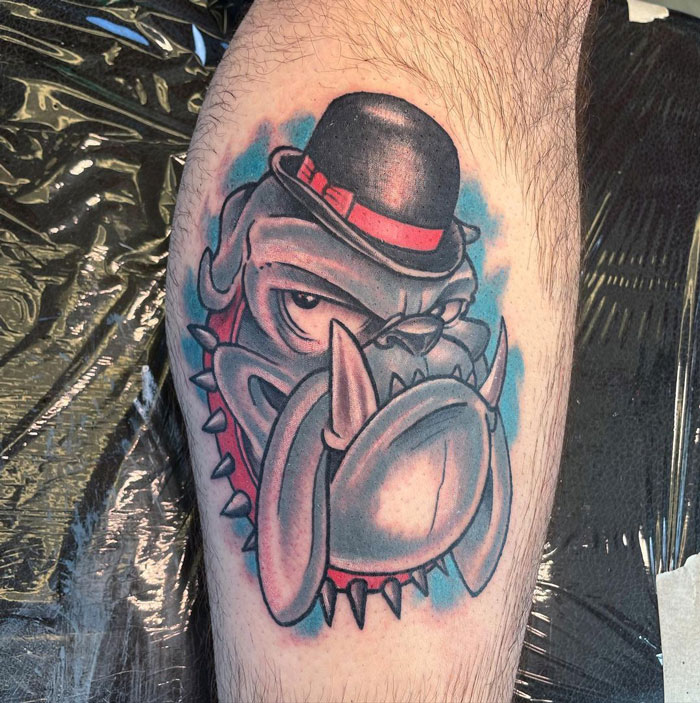 Bulldog in a hat tattoo on calf, showcasing unique and cool design ideas.