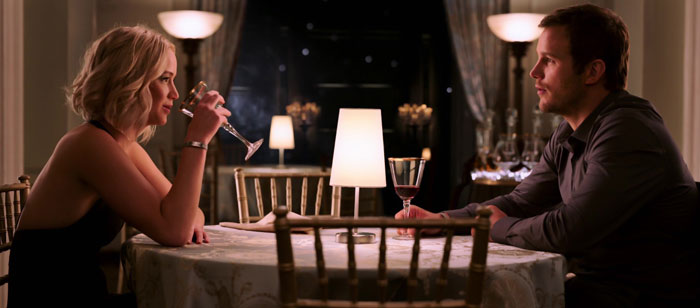 Passengers Jim and Aurora table sitting and drinking wine