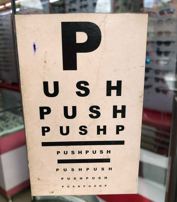 A Push/Pull Sign On The Door Of A Glasses Shop