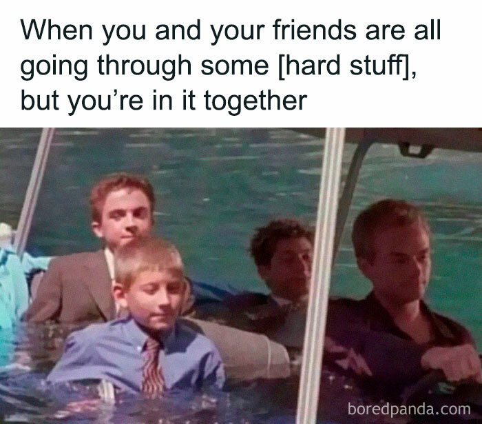 Four people in suits sitting in water, a classic internet culture meme about enduring tough times together.