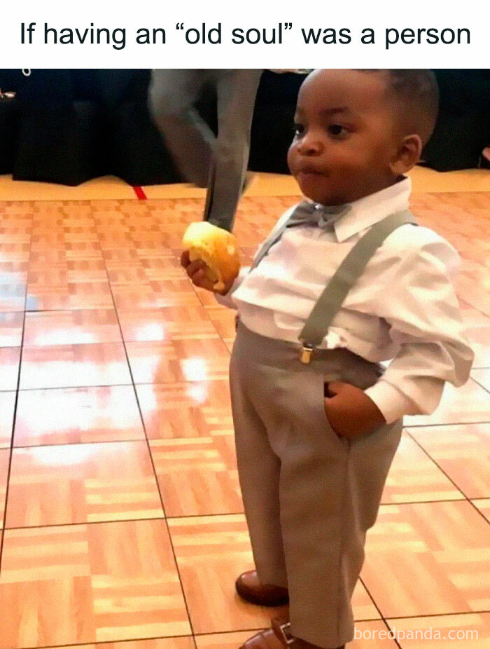 Cute child meme standing in formal attire holding a snack, epitomizing internet culture as an "old soul."