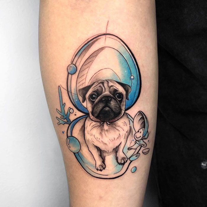 Watercolor tattoo of a pug with blue and gray accents on forearm, showcasing inkspiration.