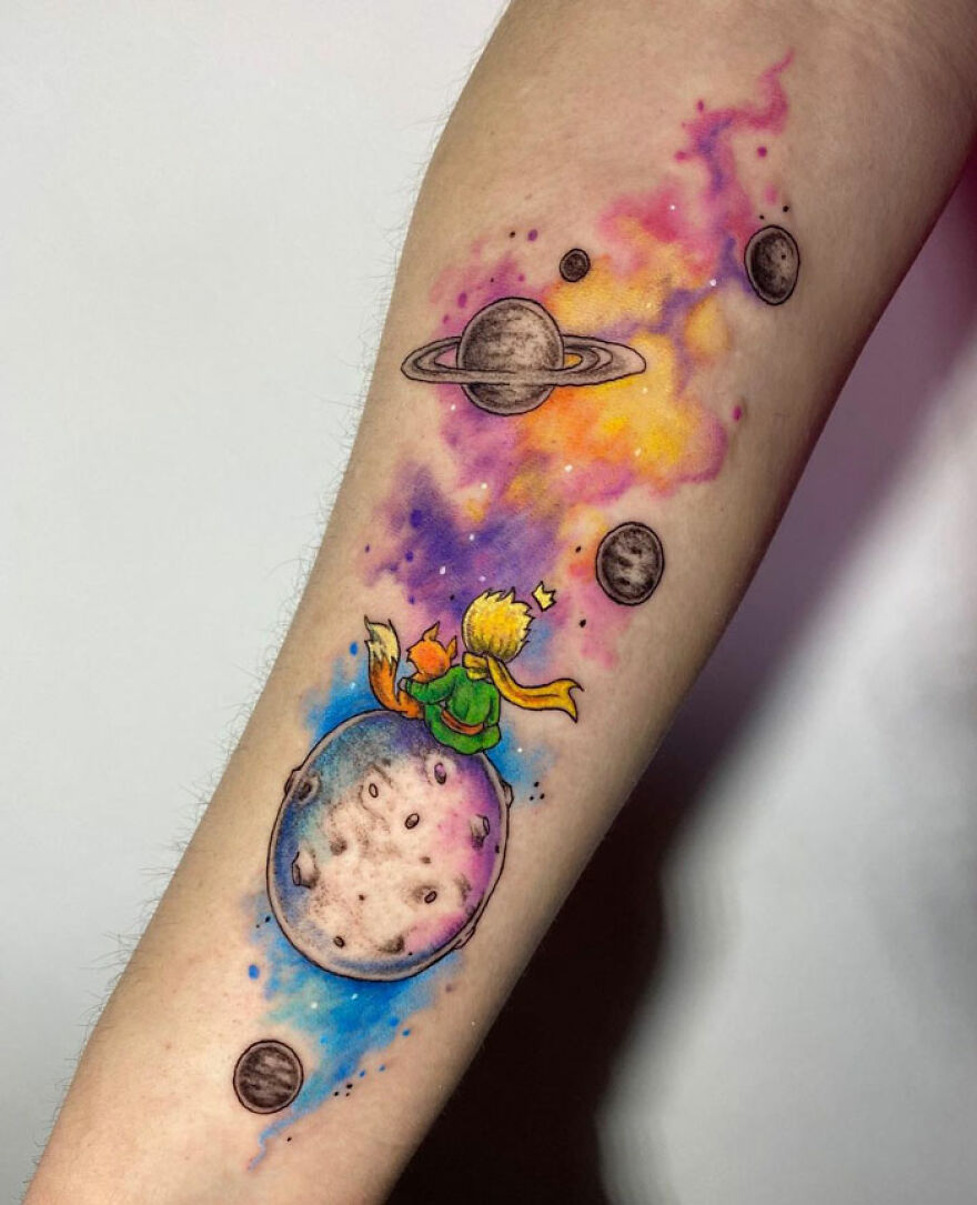 Watercolor tattoo of a little prince and fox on a colorful cosmic background with planets.