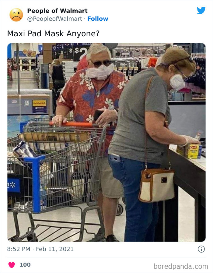 Shocking Walmart photo of a man in a floral shirt using a maxi pad as a face mask while pushing a shopping cart.