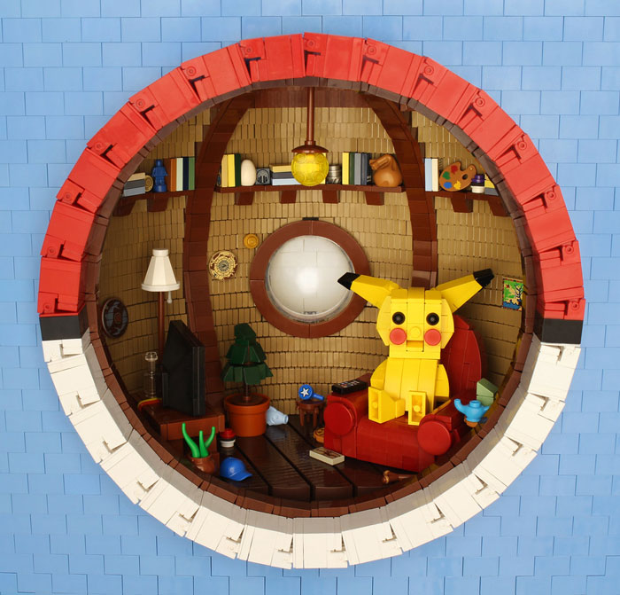 LEGO build of a cozy room with Pikachu figure sitting on a red chair inside a round window scene.