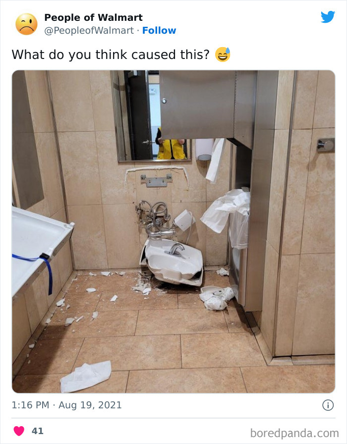 Damaged Walmart restroom with broken sink and scattered paper towels on the floor.