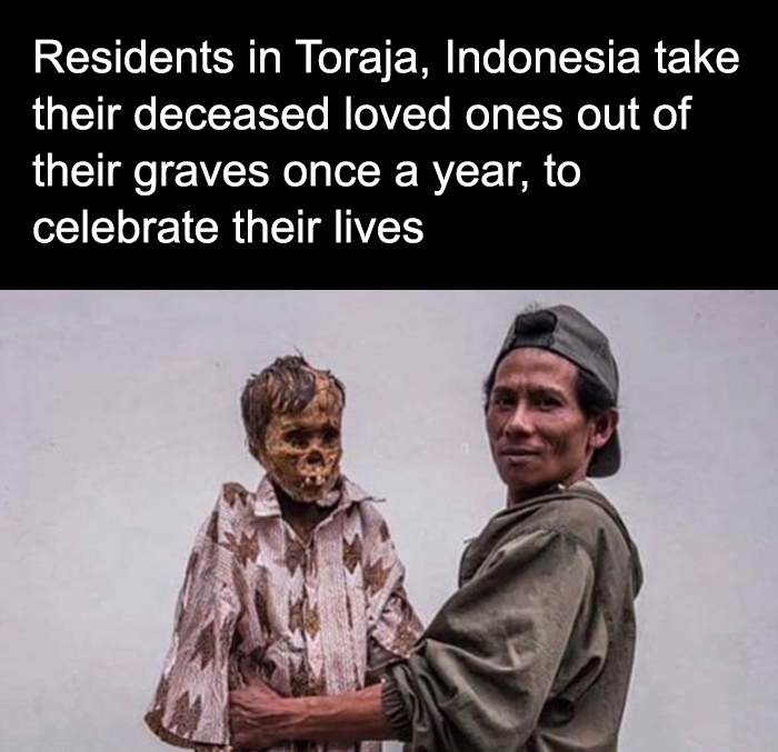Person from Indonesia holding mummified deceased loved one during a creepy ritual to celebrate their lives.