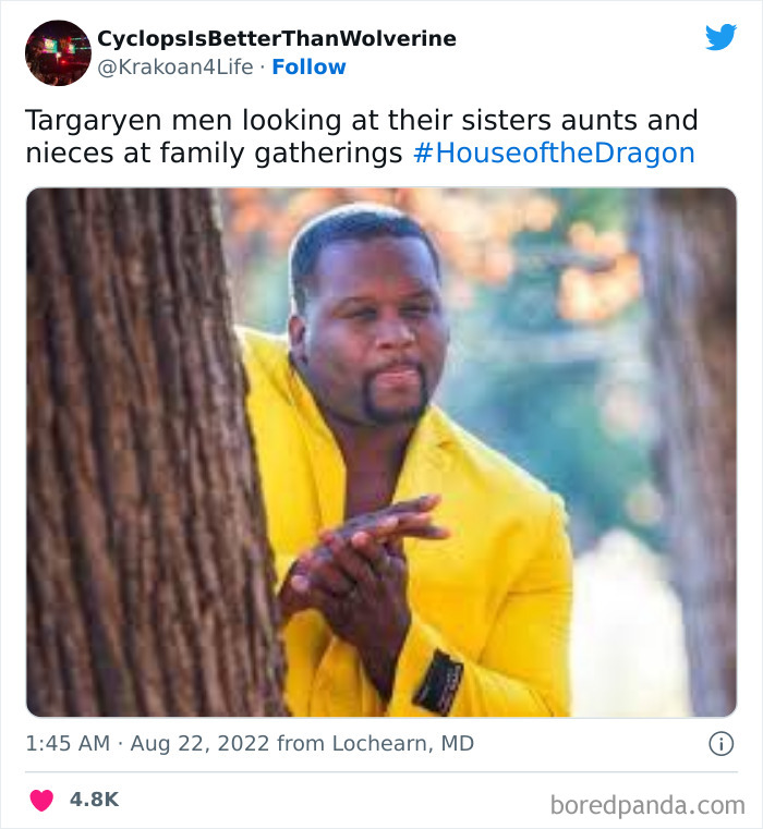 Person in yellow jacket standing behind a tree, mimicking a playful expression. House of the Dragon meme context.