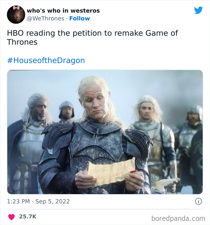 Character from House of the Dragon humorously reading a scroll, surrounded by others in medieval armor.