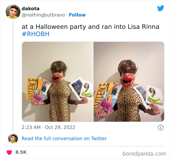 Person in a leopard print suit and oversized lips mask holding signs at a Halloween party, showcasing Halloween costume creativity.