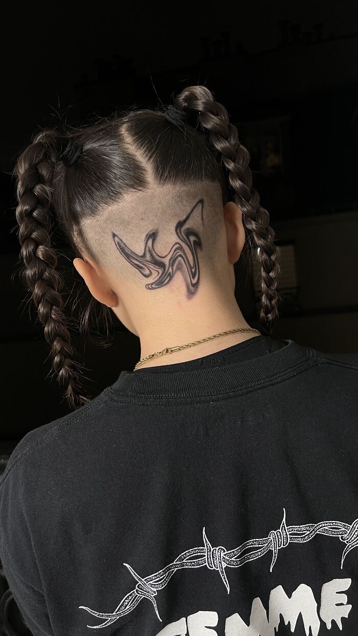 Under-hair tattoo design inspired by traditional marbling, person with braided hair. Under-hair tattoo design inspired by traditional marbling, person with braided hair.
