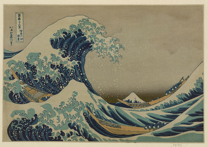 Famous landscape painting of a large wave with boats, symbolizing power and nature's beauty.