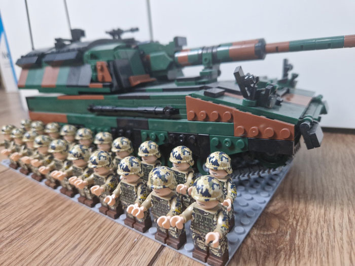 LEGO builds of a camouflaged military tank and rows of soldier minifigures, showcasing incredible creative detail.