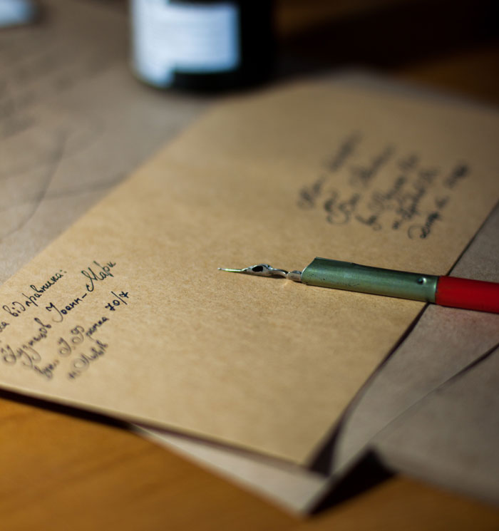 Calligraphy pen on brown paper, showcasing creative fun activities to do at home.