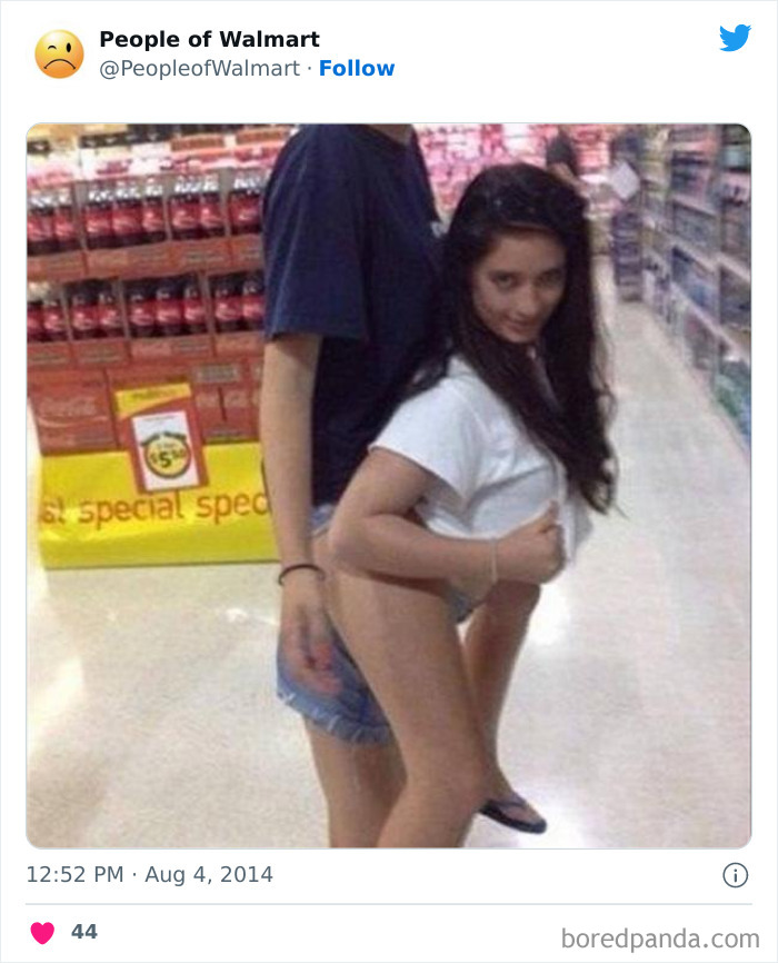 Bizarre Walmart photo featuring two people posing awkwardly in an aisle, capturing attention with unusual antics.