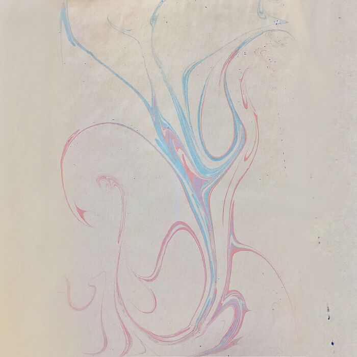 Abstract marbling design with blue and pink swirls forming a flowing pattern, reminiscent of traditional Sernakkab art. Abstract marbling design with blue and pink swirls forming a flowing pattern, reminiscent of traditional Sernakkab art.